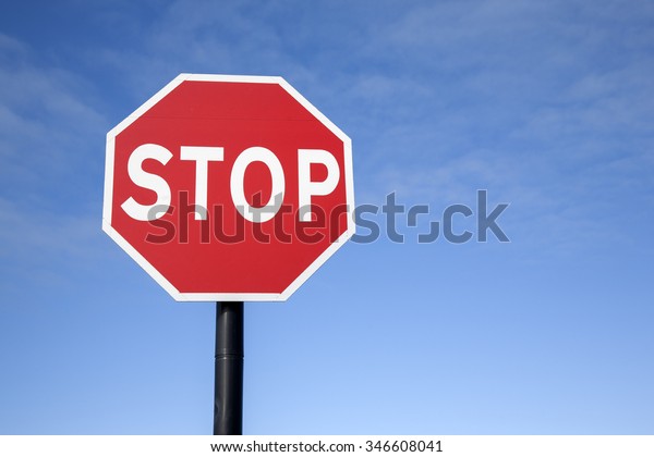 Red Stop Traffic
Sign on Blue Sky Background