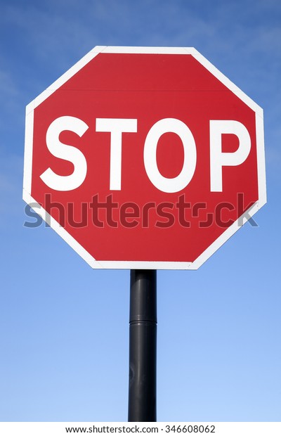 Red Stop Traffic\
Sign on Blue Sky Background