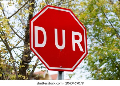 Red stop traffic sign written in Turkish. DUR symbol is a traffic regulator. Sign to stop cars.