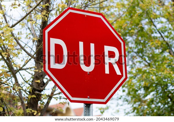 Red stop traffic sign\
written in Turkish. DUR symbol is a traffic regulator. Sign to stop\
cars.