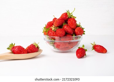 Red strawberries in a cup spoon with strawberries on a white background. - Shutterstock ID 2172321093