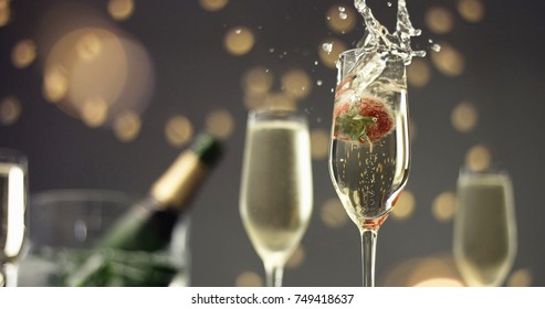 Red Strawberry Floating In Bubbles In A Glass Of Sparkling Wine On Gray Background