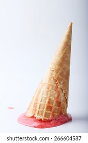 red strawberry ice cream cone dropped melt on ground