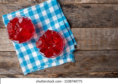 Red strawberry jelly on wooden background