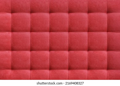 Red suede leather background for the wall in the room. Interior design, headboards made of furniture fabric, furniture upholstery. Classic checkered pattern for furniture, wall, headboard