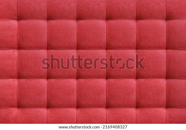 Red\
suede leather background for the wall in the room. Interior design,\
headboards made of furniture fabric, furniture upholstery. Classic\
checkered pattern for furniture, wall,\
headboard