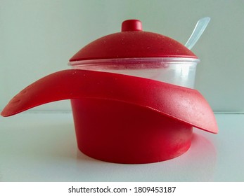 A Red Sugar Bowl On The Table