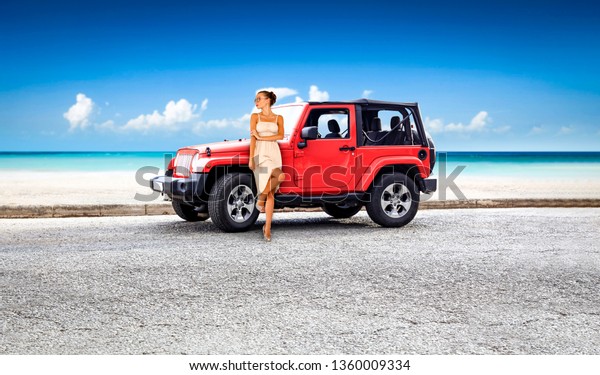 Red summer car with slim young\
woman. Summer road with sea landscape and beach. Free space for\
your decoration or text. Summer time on Gran Canaria island.\
