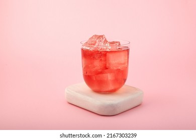 Red Summer Non-alcoholic Drink With Ice. Fruit Iced Tea On Pink Background. Rose Hibiscus Refreshing Drink.