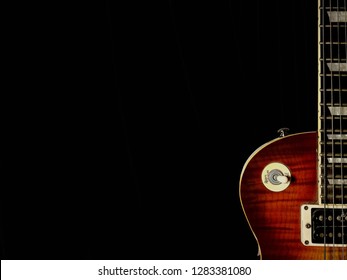 Red sunburst guitar isolated on black background