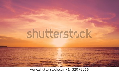 Red sundown sea. The coast of the Caribbean Sea, the yellow sun touches the horizon, beautiful orange clouds around the sun. Amazing view from the beach to the red sundown sea. Beautiful sea landscape