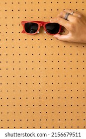 Red Sunglasses On Peg Board.