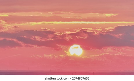 The Red Sunset Sun Sets Behind The Clouds In The Evening Sky, Time Lapse