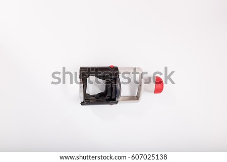 Red superior quality stamp with wooden stamper isolated on white background.