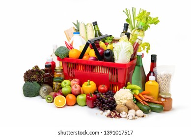 Red supermarket shopping basket full of  fresh organic colorful foods and groceries with assorted ingredients on white background - Shutterstock ID 1391017517