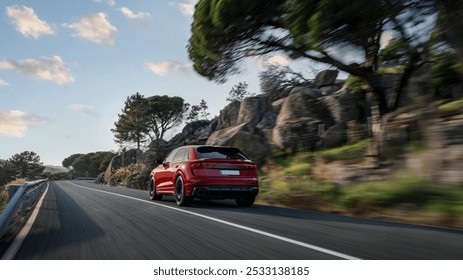 A red SUV driving swiftly along a scenic mountain road lined with rocky terrain and lush trees under a bright, partly cloudy sky - Powered by Shutterstock