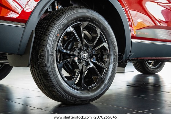 Red\
SUV Renault Arkana at showroom. Bridgestone tire is mounted on cast\
aluminum rim. Close-up of rear right wheel. Renault car dealership\
in Mega Adygea. Krasnodar, Russia - August 26,\
2021