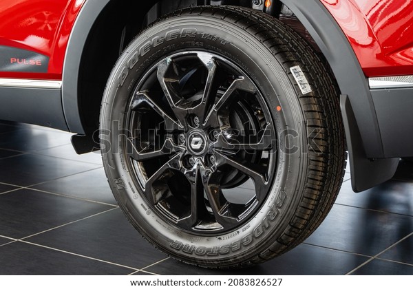 Red\
SUV Renault Arkana at showroom. Bridgestone tire is mounted on cast\
aluminum rim. Close-up of rear left wheel. Renault car dealership\
in Mega Adygea. Krasnodar, Russia - August 26,\
2021