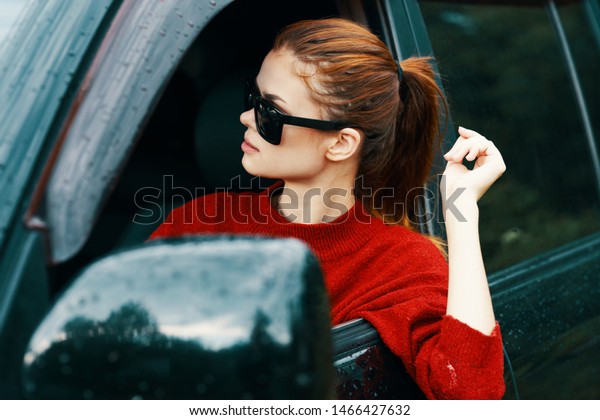 Red sweater woman with glasses car rearview mirror
confidence red hair driver