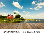 Red Swedish house with wooden terrace
