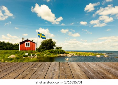 Red Swedish house with wooden terrace