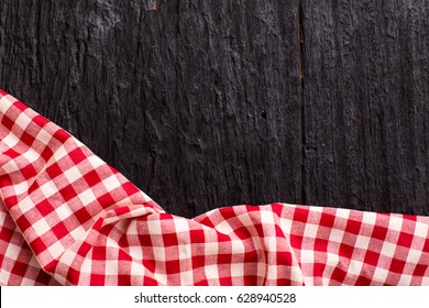 Red Table Cloth On Black Wooden Background