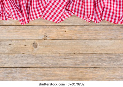 Red table cloth on rustic wooden background.