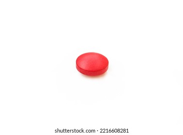 Red tablet pill medication isolated on white background.One single medicine