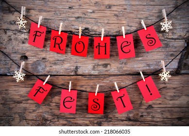 Red Tags Hanging on a Line with the German Words Frohes Fest which means Merry Christmas - Shutterstock ID 218066035
