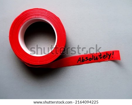 Red tape on gray background with handwritten text ABSOLUTELY! means to agree completely - beyond any doubt ,  totally certain or very clear explanation or without exception