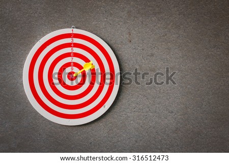 Red target aim, symbol of goal and objective over gray grunge background, business concept
