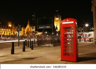 Red Telephone Booth at night, Victoria Tower in the distance. Red phone booth is one of the most famous London icons.  - Powered by Shutterstock