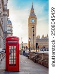 Red telephone box on Parliament square and Big Ben tower, London, UK