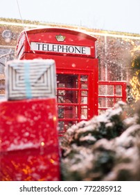 Red Telephone Box In The Snow. Telephone Booth In Winter. Christmas Tree, Gifts, Phone Booth.