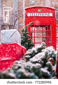 Red Telephone Box In The Snow. Telephone Booth In Winter. Christmas Tree, Gifts, Phone Booth.