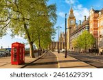 Red telephone boxes on Victoria embankment and Big Ben tower, London, UK