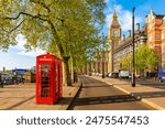 Red telephone boxes on Victoria embankment and Big Ben tower, London, UK