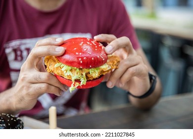 Red Tex Mex Chicken Burger In Hand