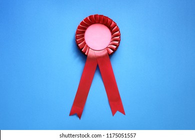 Red Textile Award Rosette With Ribbons