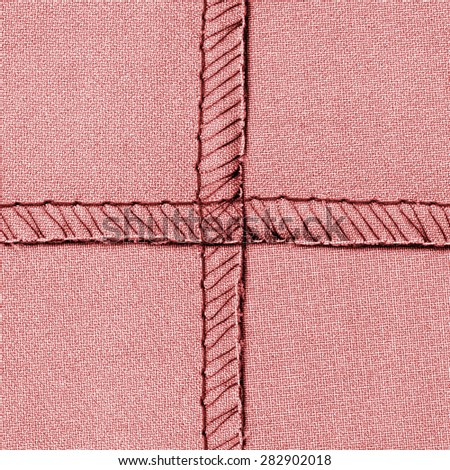 red textile texture with  inseams in shape of the cross