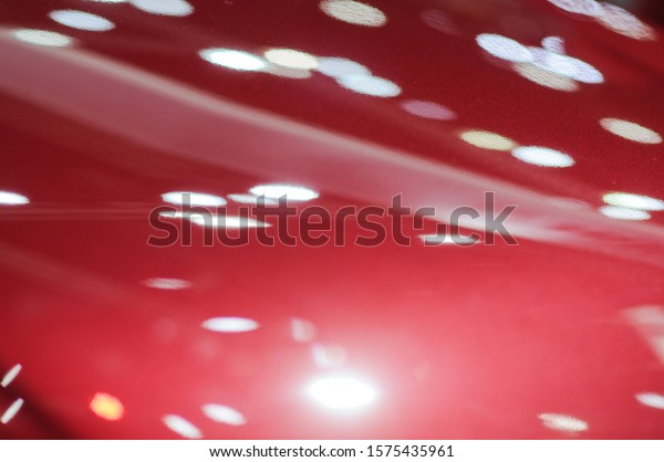 The red texture\
of the car hood is\
beautiful.