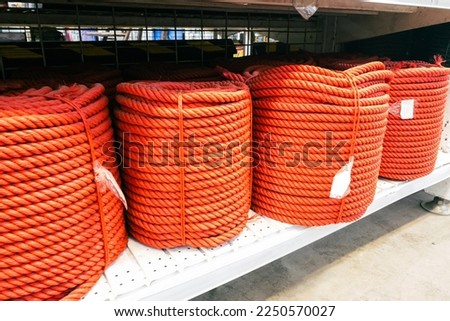 Red thick nylon rope in a building material store.