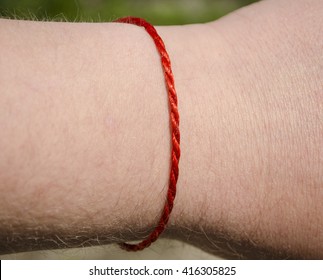 Red Thread With A Cross On The Hand Of A Close-up Stock, 54% OFF