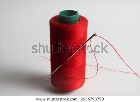red thread spool with needle confection
