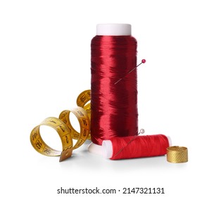 Red Thread Spools, Thimble, Measuring Tape And Ball Pins On White Background