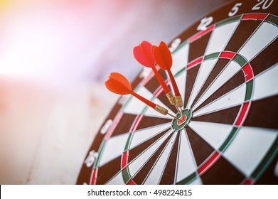 red three darts arrows in the target center business goal concept - Shutterstock ID 498224815