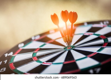 red three darts arrows in the target center - Shutterstock ID 689069563