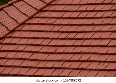 Red Tile Shingles Covering Roof Of Commercial Building.