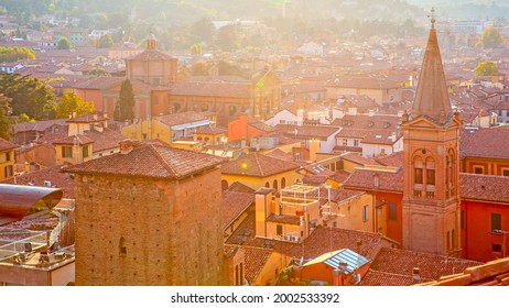 Red tiled roofs of Bologna city in sunlight at sunset, Italy. Italian cityscape