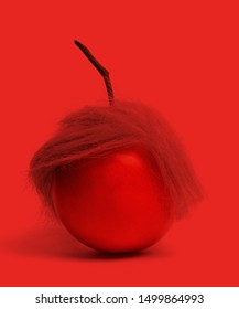 Red Tomato With Funny Hair Looking Like A Famous Artist, Strange Combination Of Two Things